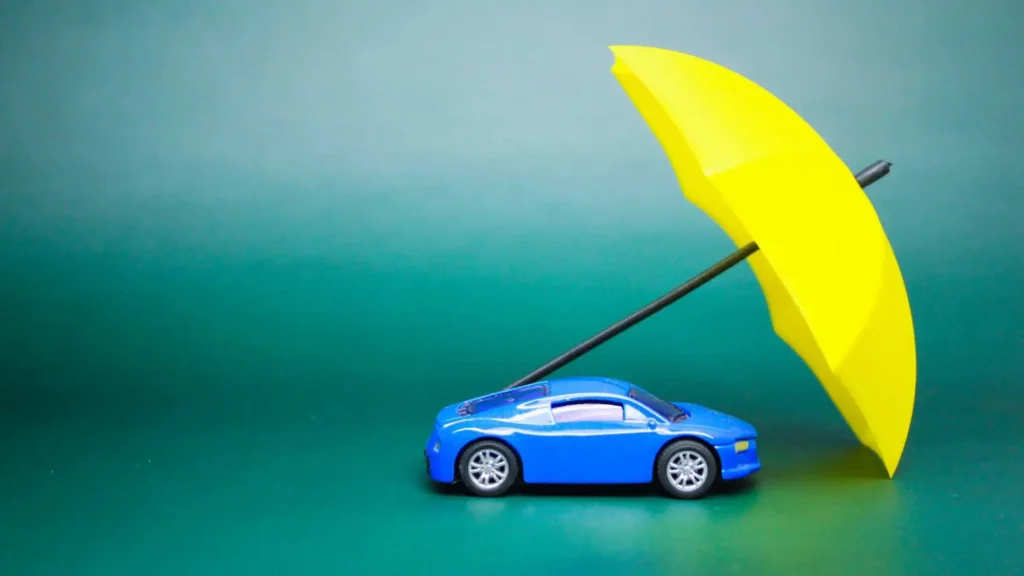 Average cost of car insurance in Alabama concept with blue car under umbrella.