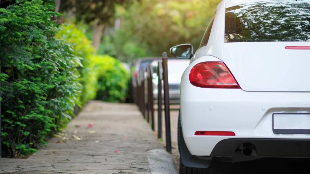 White car parked on roadside representing average cost of car insurance in Alaska
